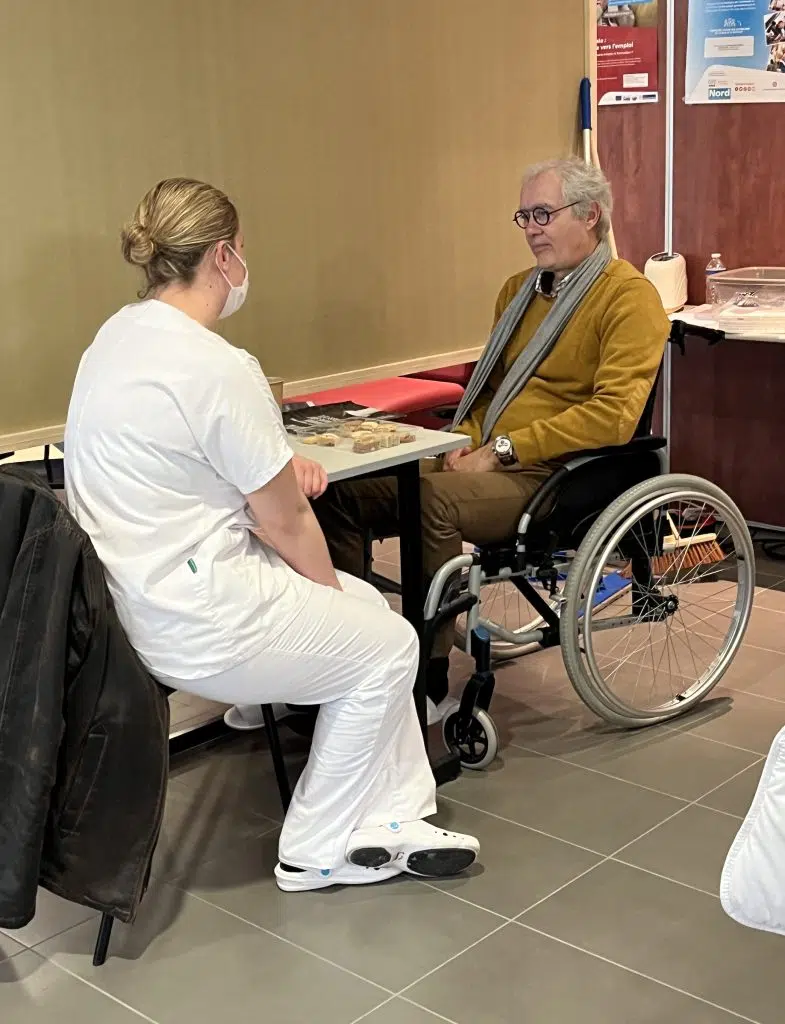 Jeune écoute personne âgée fauteuil roulant 